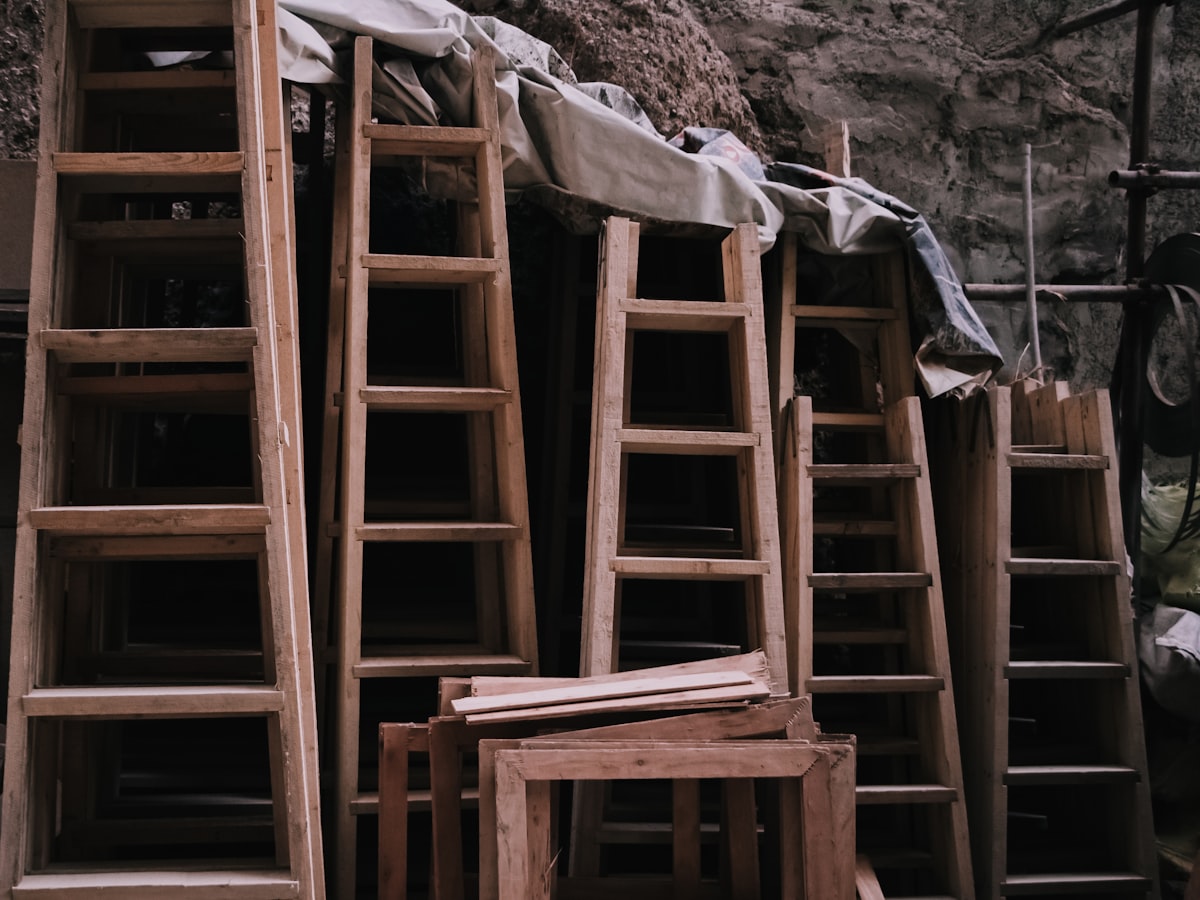 a pile of wooden ladders sitting next to each other related to The Ultimate Guide to Bunk Bed Ladders