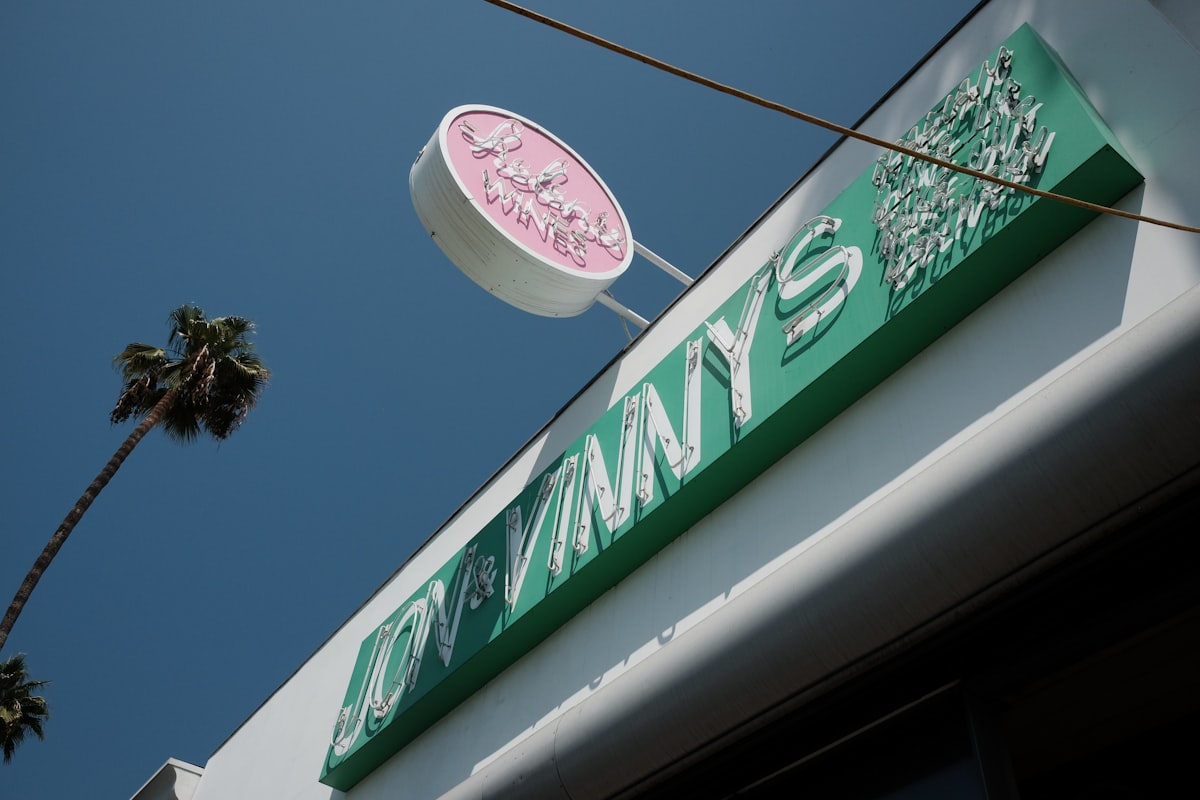 a pink and green sign on the side of a building related to JCPenney Swag Valances: Elevating Your Home Decor