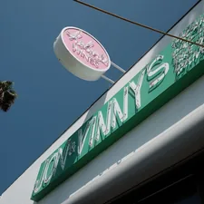 a pink and green sign on the side of a building related to JCPenney Swag Valances: Elevating Your Home Decor