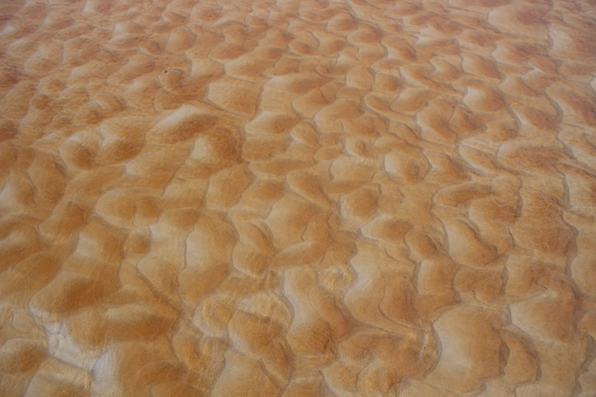 a plane is flying over a sandy area related to Velvet Quilted Coverlet
