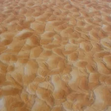 a plane is flying over a sandy area related to Velvet Quilted Coverlet