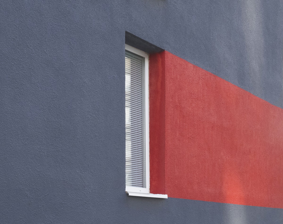 a red and blue building with a white window related to Elevate Your Windows with a Red Polka Dot Valance
