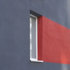 a red and blue building with a white window related to Elevate Your Windows with a Red Polka Dot Valance