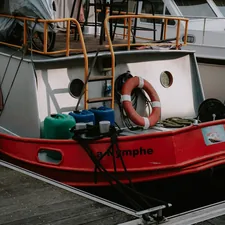a red and white boat docked at a dock related to The Ultimate Dockside Experience: Uniting Two Loves