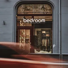 a red car driving past a store front related to Score Big with Bed Bath and Beyond Clearance Sales