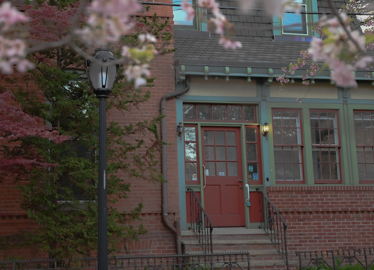 a red door is on the side of a brick building related to Charming Getaways: Uncovering the Best Bed and Breakfasts in Connecticut