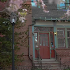 a red door is on the side of a brick building related to Charming Getaways: Uncovering the Best Bed and Breakfasts in Connecticut