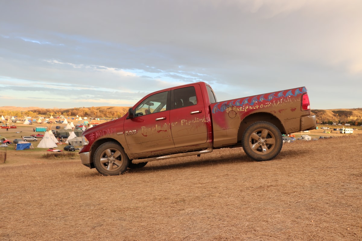 a red pickup truck parked on a dirt road related to The Art of a Perfect Pick Up Bed