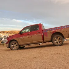 a red pickup truck parked on a dirt road related to The Art of a Perfect Pick Up Bed