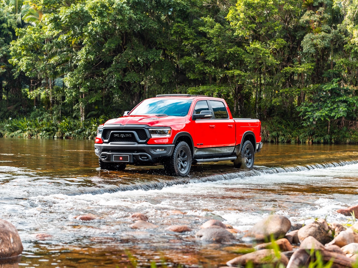 A red truck wades through the water. related to Protecting Your Truck: The Ultimate Guide to Bed Liners