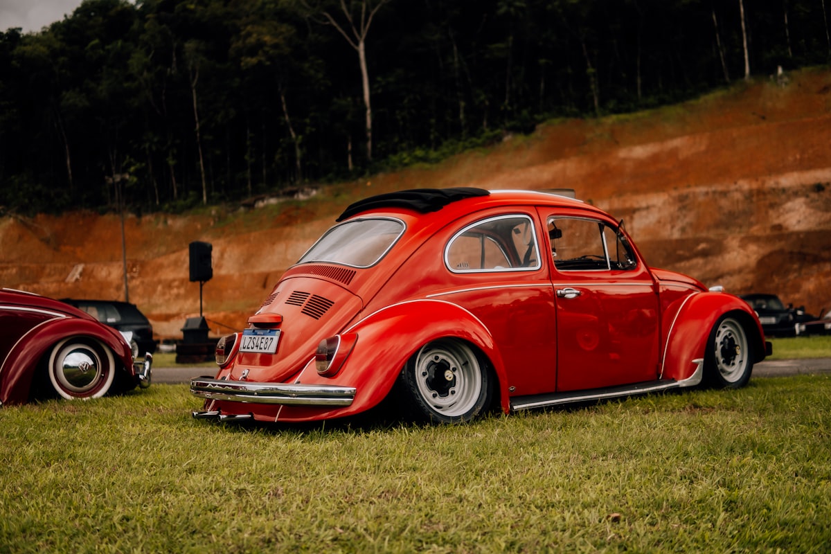 a red vw bug parked next to another red vw bug related to Upgrading Your MK4 Golf with a Front Valance