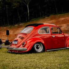 a red vw bug parked next to another red vw bug related to Upgrading Your MK4 Golf with a Front Valance