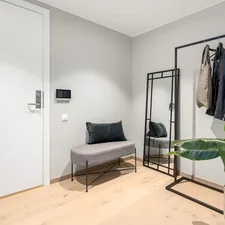 A room with a couch and a coat rack related to Transform Your Entryway with a Metal Storage Bench and Coat Rack