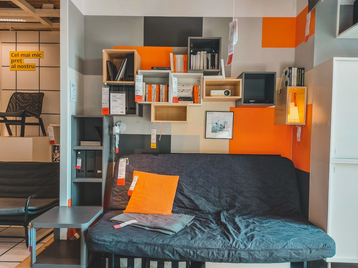 a room with a couch and shelves related to The Ultimate Space Saver: Friheten Sofa Bed