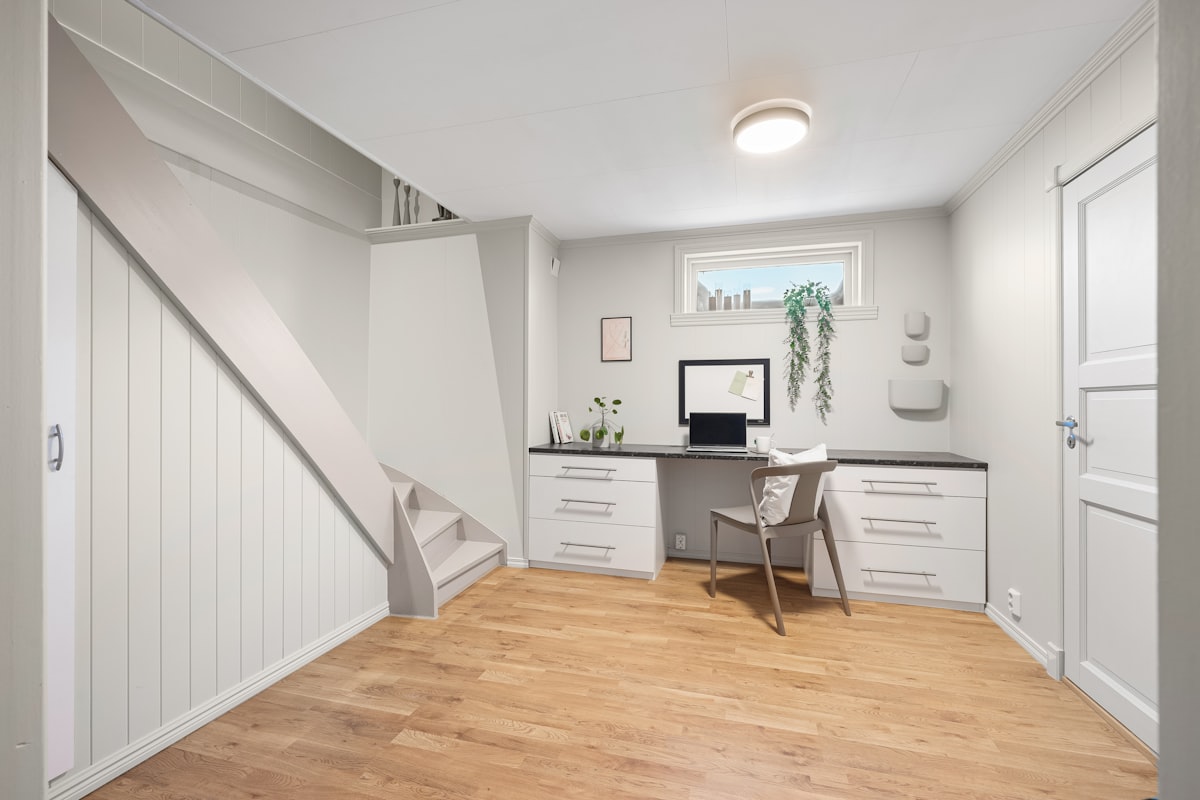 A room with a desk and a chair in it related to Maximize Space and Style with a Platform Bed with Storage Drawers