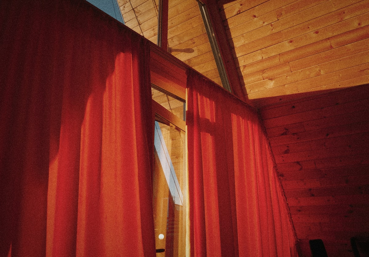 a room with a red curtain and a ceiling fan related to Target Valances Curtains: Elevating Your Home Decor