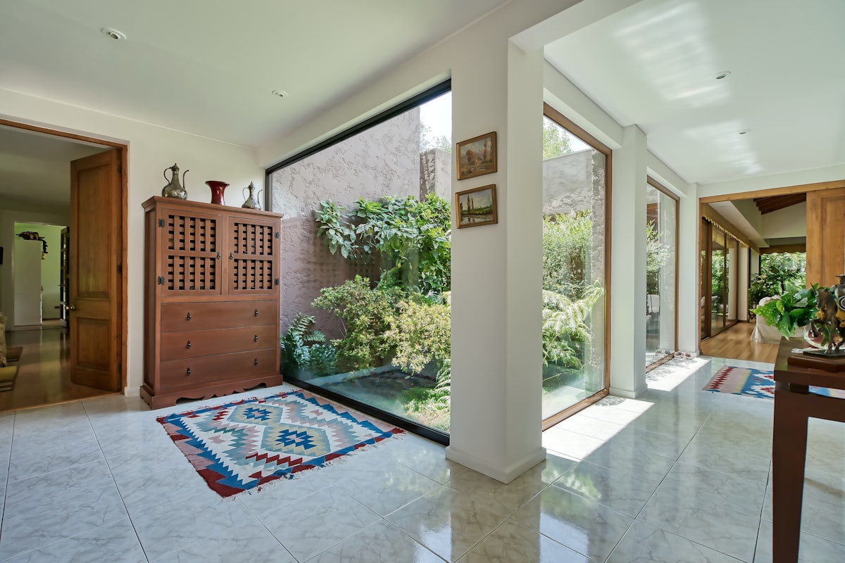 a room with a rug on the floor and a large window related to Samantha Entryway Collection: Elevating Your Home's First Impression