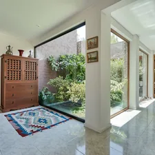a room with a rug on the floor and a large window related to Samantha Entryway Collection: Elevating Your Home's First Impression