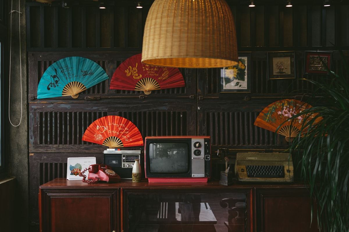 a room with a television, fan, and a lamp related to Elegance Meets Function: Exploring Asian Sideboards and Buffets