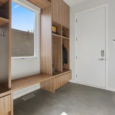 a room with a window and a door related to Elevate Your Entryway: The Ultimate Guide to Benches with Storage and Hooks