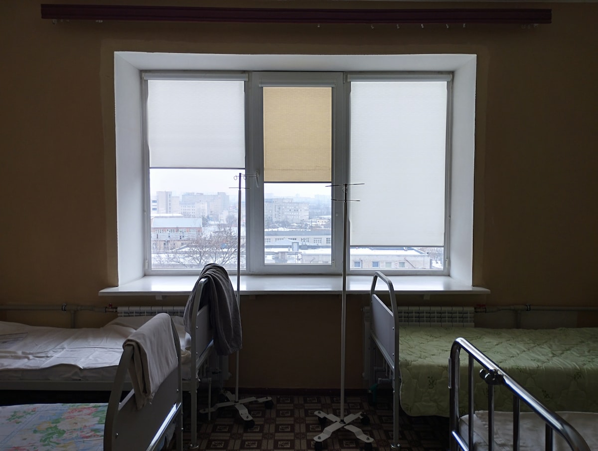 A room with two beds and a window related to Essential Accessories for a Comfortable Sleep: Bed Rails for Twin Bed