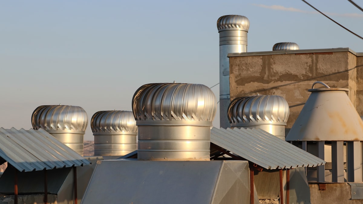 a row of metal chimneys on top of a building related to The Ultimate Guide to Cast Aluminium Chimineas