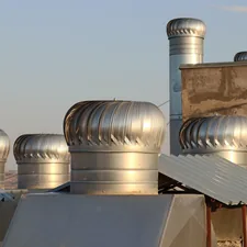 a row of metal chimneys on top of a building related to The Ultimate Guide to Cast Aluminium Chimineas