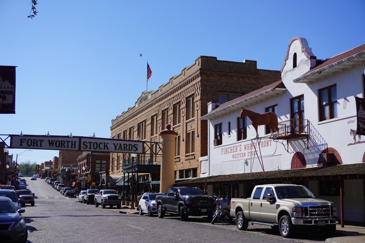 a row of parked cars on a city street related to Charming Stays in a Historic Texas Town