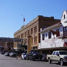 a row of parked cars on a city street related to Charming Stays in a Historic Texas Town