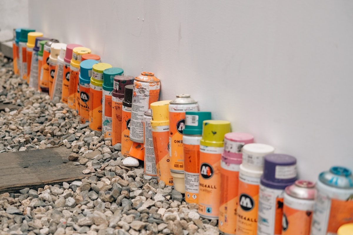 a row of spray paint cans lined up against a wall related to The Ultimate Guide to Bed Liner Spray Paint