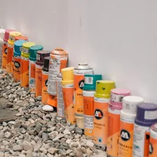 a row of spray paint cans lined up against a wall related to The Ultimate Guide to Bed Liner Spray Paint