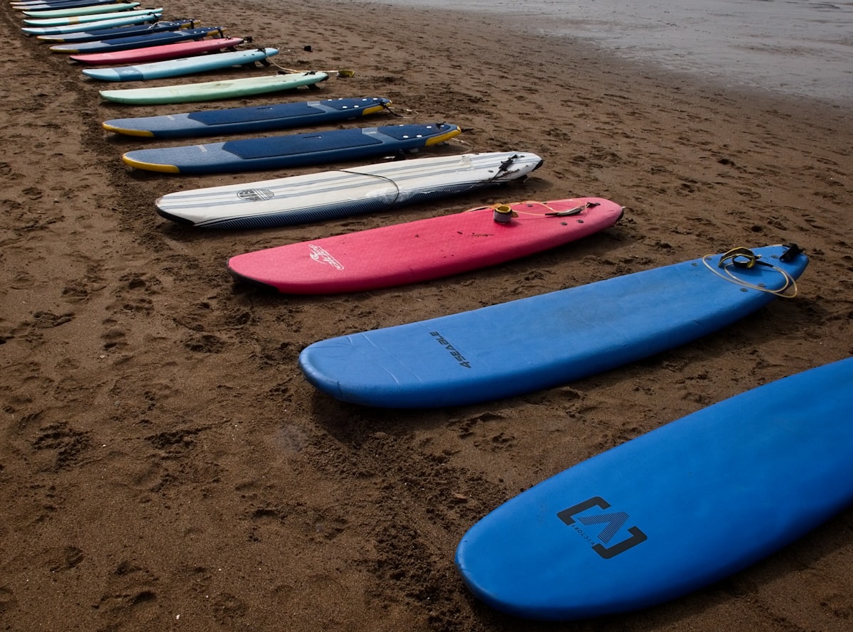 a row of surfboards sitting on top of a sandy beach related to Sideboards on Sale: Unbeatable Deals for Your Home Decor