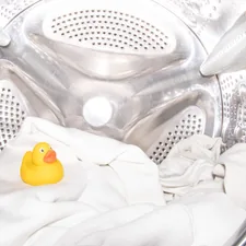 a rubber ducky toy sitting inside of a washing machine related to Conquering Bed Bugs:  The Laundry Detergent Weapon
