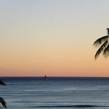 a sailboat is in the distance on the ocean related to Exploring the Best Oahu Bed and Breakfasts for a Unique Hawaiian Escape
