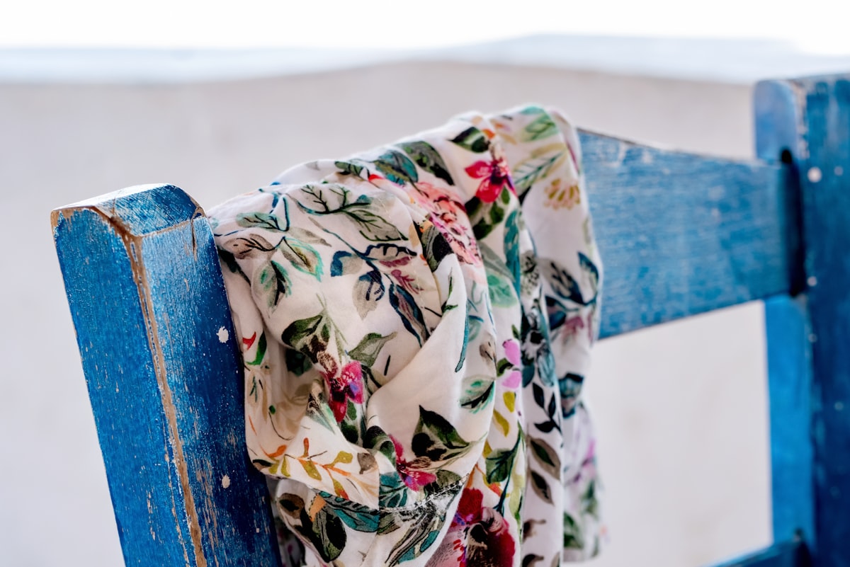 a scarf draped over a blue wooden bench related to Scarf Valence Pattern Ideas