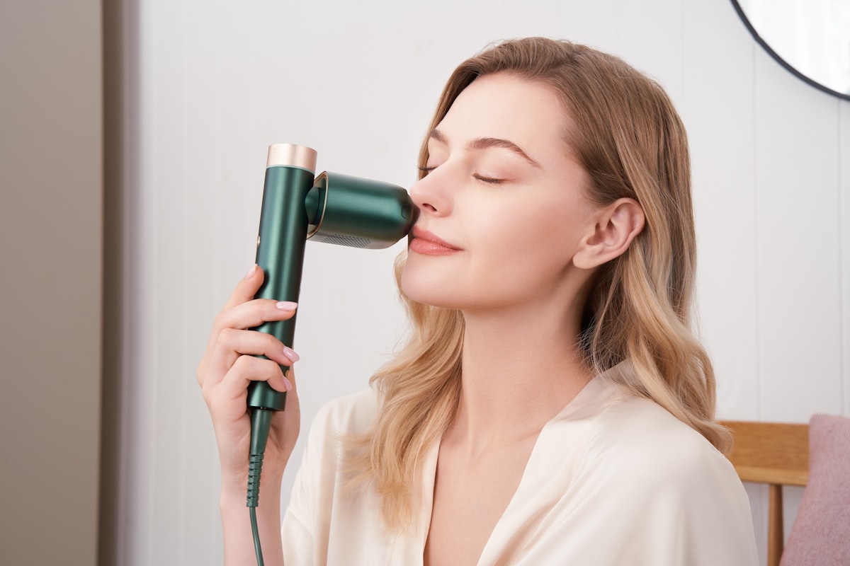 A serene moment is captured as a model gently uses a laser hair removal device on her face, showcasing the product's versatility and gentle application. related to Revitalize Your Skincare Routine with Face Steamers from Bed Bath & Beyond