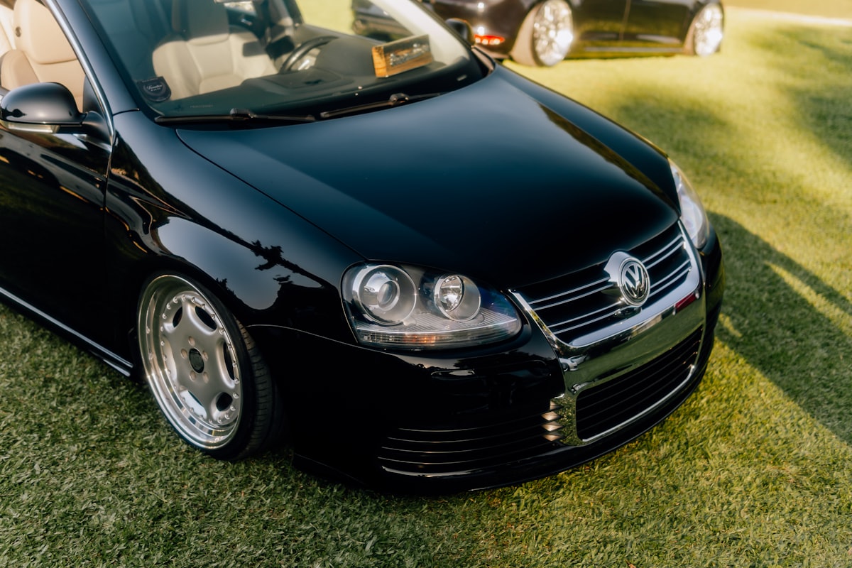 A shiny black car is parked on the grass. related to Upgrading with Style: MK4 Jetta Valance