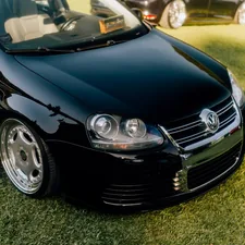 A shiny black car is parked on the grass. related to Upgrading with Style: MK4 Jetta Valance