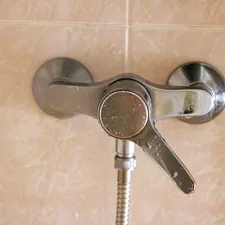 A shower faucet with a hand shower head related to How to Install a Bidet: A Step-by-Step Guide