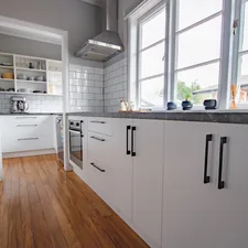 A simple white kitchen with black handles in an old train house. Kitchen designed in New Zealand by Kitchens Made Ezi related to Revolutionize Your Kitchen with the Perfect Sideboard