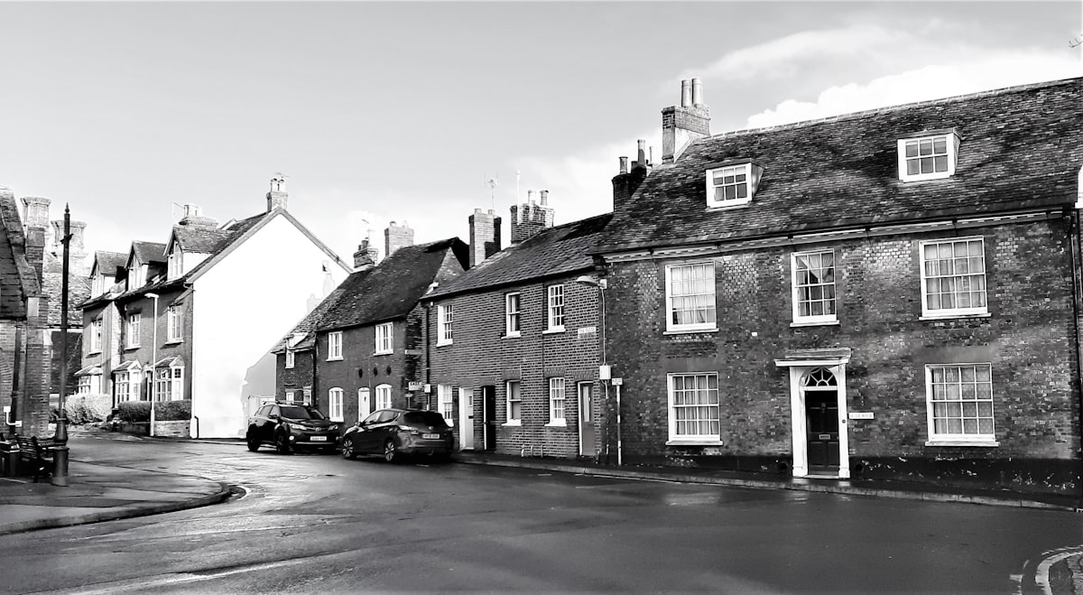 A small row of houses in Blandford Forum constructed after the last great fire with traditional Georgian architecture featuring red brick façades, construction est. 18th century. Image Captured 2021.  related to Charming Stay at a Historic Bed & Breakfast