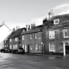A small row of houses in Blandford Forum constructed after the last great fire with traditional Georgian architecture featuring red brick façades, construction est. 18th century. Image Captured 2021.  related to Charming Stay at a Historic Bed & Breakfast