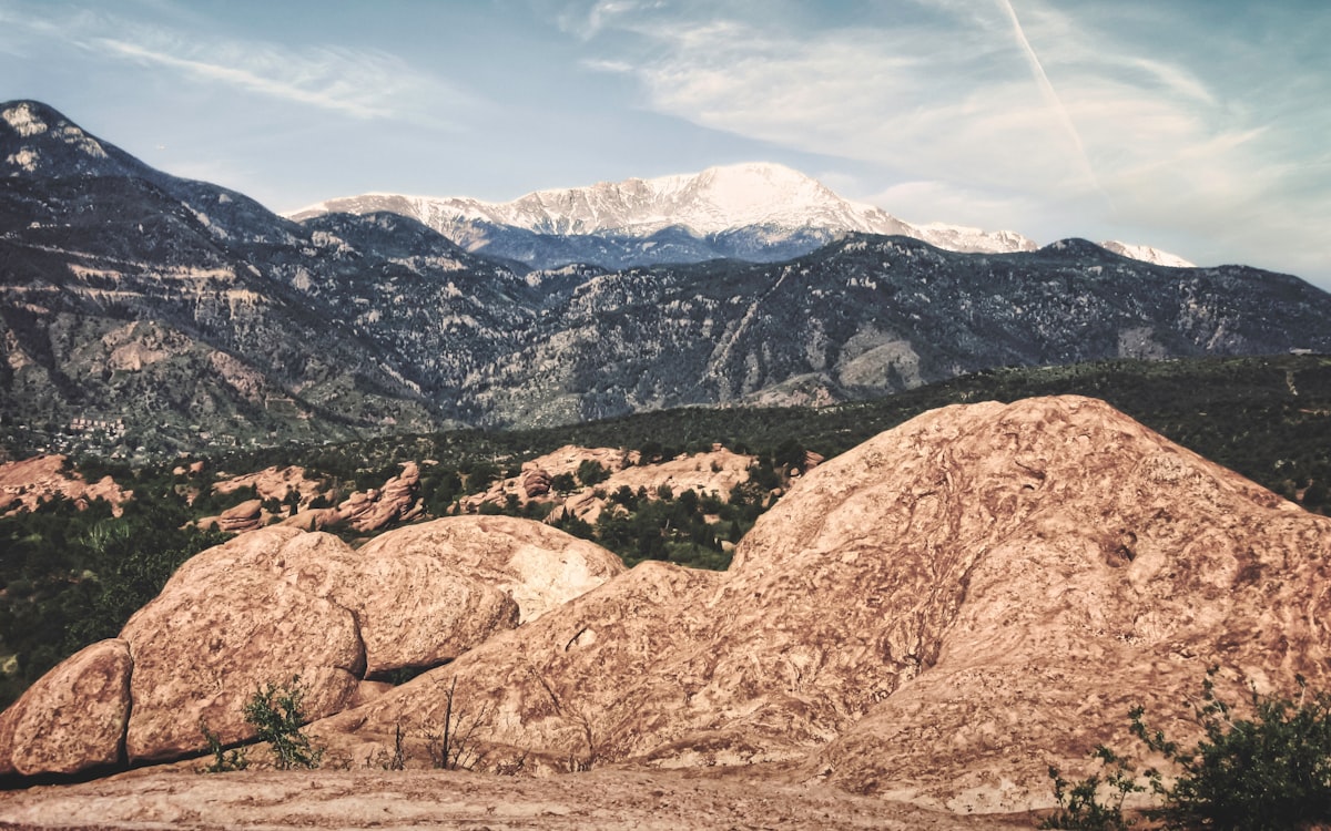 A snow-capped Pike's Peak in the distance from Garden of the Gods Park outside Colorado Springs. The winding road up the mountain side on the left leads to the Cave of the Winds (May, 2016). related to Bed Bath & Beyond in Boulder: A Shopper's Paradise?