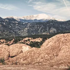 A snow-capped Pike's Peak in the distance from Garden of the Gods Park outside Colorado Springs. The winding road up the mountain side on the left leads to the Cave of the Winds (May, 2016). related to Bed Bath & Beyond in Boulder: A Shopper's Paradise?