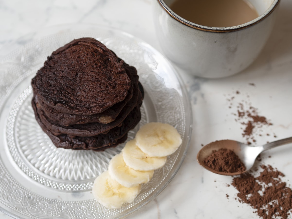 a stack of cookies on a plate next to a cup of coffee related to The Ultimate Guide to Breakfast in Bed Tables: Elevate Your Morning Routine