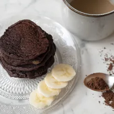 a stack of cookies on a plate next to a cup of coffee related to The Ultimate Guide to Breakfast in Bed Tables: Elevate Your Morning Routine