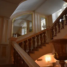 a staircase with a mirror on the wall related to Elegant Entryways: A Comprehensive Guide on How to Decorate Your Foyer
