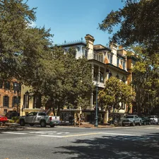 a street with cars parked on the side of it related to Savannah B&B Cottages