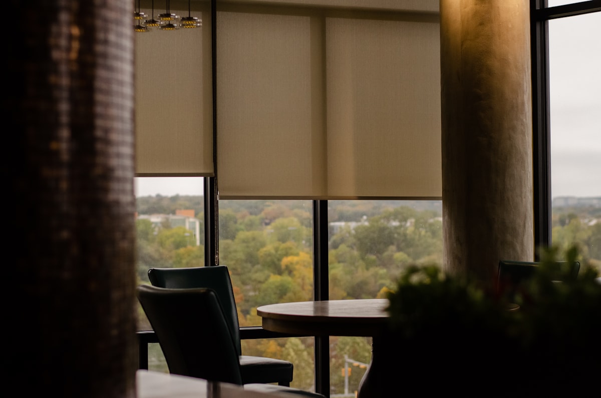 a table and chairs in a room related to Window Blinds with Valance: Elevate Your Home Decor