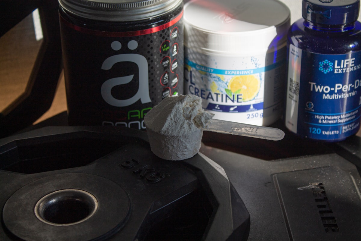a table topped with bottles of pills and other items related to Benefits of Taking BCAA Before Bed
